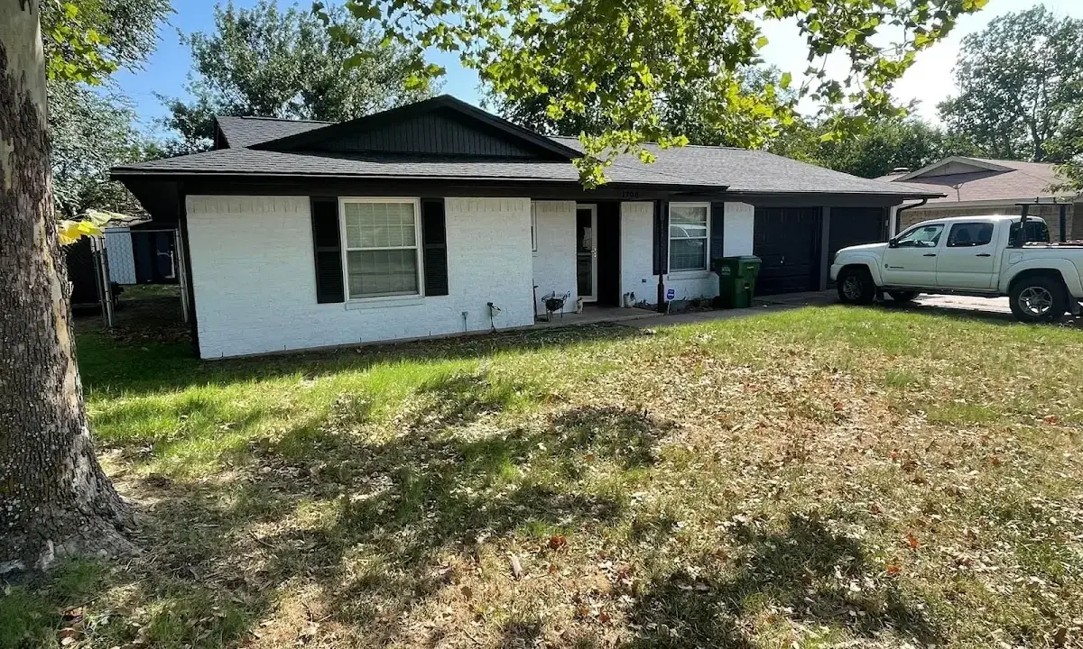 Professional roofing crew working on a residential roof in Sodus